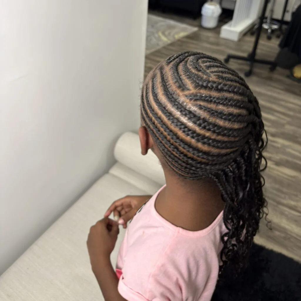 Close-up of braiding detail on a young client, side view